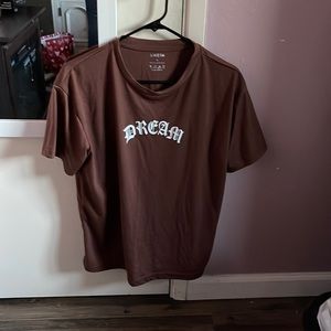 Brown T-shirt that says “dream” with a butterfly on the back